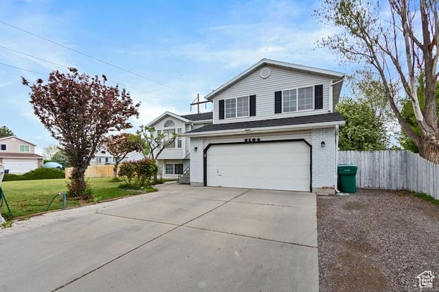 3184 W 5025 S, Roy, UT 84067 - view of front of home with a garage, a front lawn, fence, brick siding, and driveway