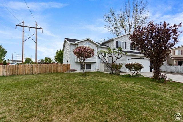 3184 W 5025 S, Roy, UT 84067 - view of front facade featuring fence, driveway, a front yard, and a garage
