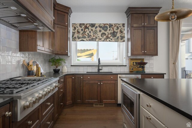 1478 W 400 N, West Bountiful, UT 84087 - kitchen featuring dark countertops, dark wood-type flooring, custom range hood, a sink, and appliances with stainless steel finishes