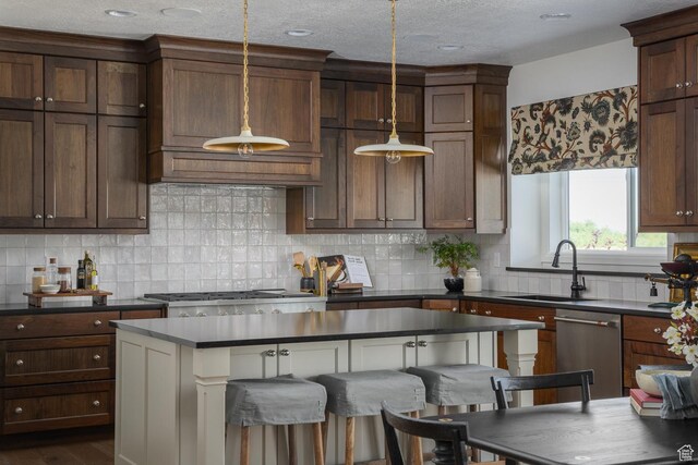1478 W 400 N, West Bountiful, UT 84087 - kitchen featuring backsplash, decorative light fixtures, dark countertops, stainless steel dishwasher, and a sink