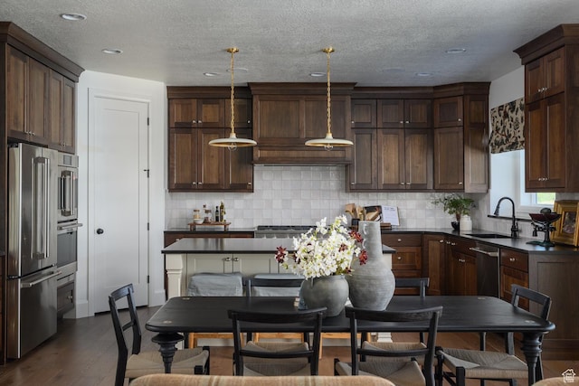 1478 W 400 N, West Bountiful, UT 84087 - kitchen with a sink, dark brown cabinets, dark countertops, and stainless steel appliances