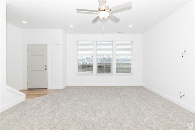 spare room with baseboards, ceiling fan, recessed lighting, and light colored carpet