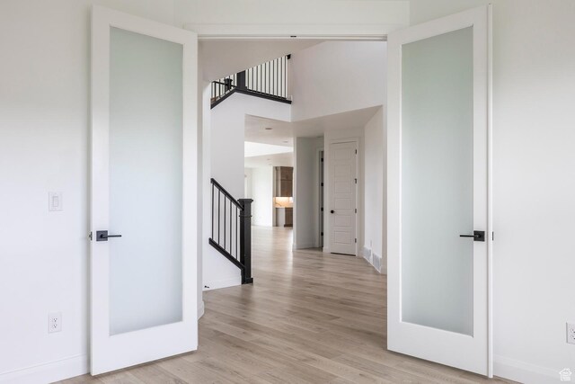 5081 W Sequoia Cir, Highland, UT 84003 - corridor with a towering ceiling, baseboards, stairway, and light wood-type flooring