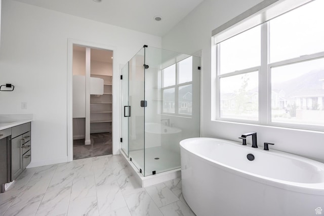 5081 W Sequoia Cir, Highland, UT 84003 - bathroom featuring a walk in closet, a freestanding tub, a shower stall, baseboards, and marble finish floor