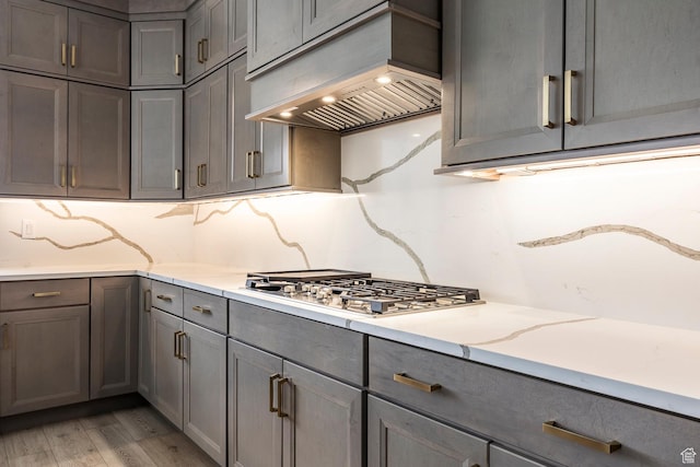 5081 W Sequoia Cir, Highland, UT 84003 - kitchen with gray cabinetry, tasteful backsplash, stainless steel gas cooktop, and custom range hood