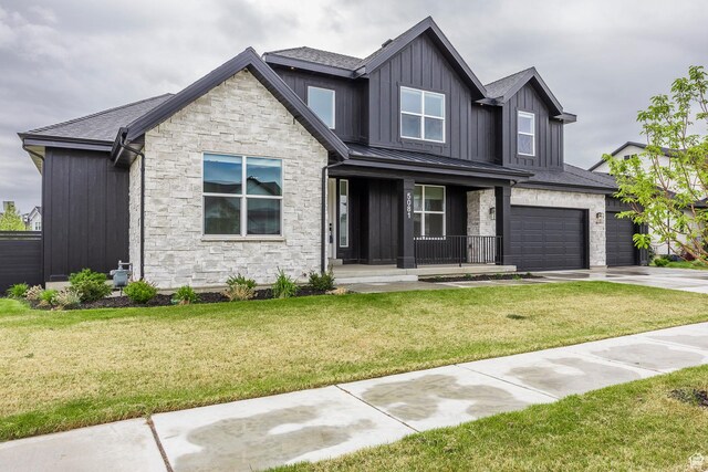 5081 W Sequoia Cir, Highland, UT 84003 - craftsman house featuring a front lawn, stone siding, board and batten siding, concrete driveway, and a porch