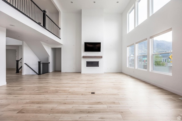 5081 W Sequoia Cir, Highland, UT 84003 - unfurnished living room featuring light wood finished floors and a towering ceiling
