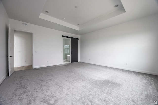 5081 W Sequoia Cir, Highland, UT 84003 - carpeted spare room featuring baseboards, visible vents, a barn door, and a raised ceiling