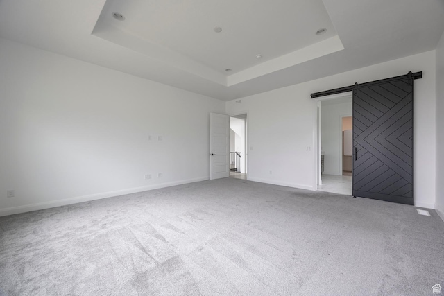 5081 W Sequoia Cir, Highland, UT 84003 - interior space featuring baseboards, light colored carpet, a barn door, and a raised ceiling