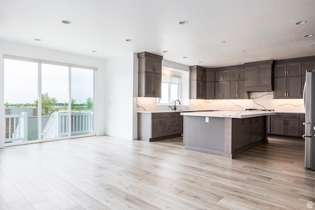 5081 W Sequoia Cir, Highland, UT 84003 - kitchen featuring light countertops, stainless steel appliances, decorative backsplash, and light wood-type flooring