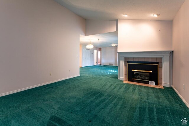 954 E 5650 S, South Ogden, UT 84405 - unfurnished living room with a tiled fireplace, baseboards, carpet flooring, and visible vents
