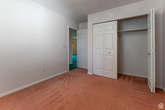 954 E 5650 S, South Ogden, UT 84405 - unfurnished bedroom featuring baseboards, carpet flooring, a textured ceiling, and a closet