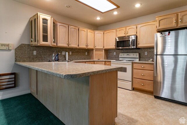 954 E 5650 S, South Ogden, UT 84405 - kitchen featuring a peninsula, appliances with stainless steel finishes, light brown cabinetry, and glass insert cabinets