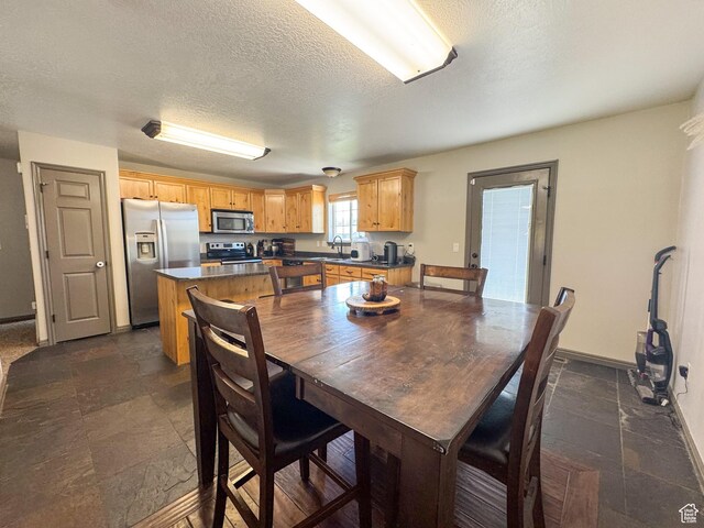 3261 S 1500 W, Nibley, UT 84321 - dining area with a textured ceiling, baseboards, and stone tile flooring