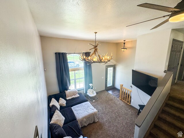 3261 S 1500 W, Nibley, UT 84321 - carpeted living area featuring a textured ceiling, ceiling fan with notable chandelier, and stairs
