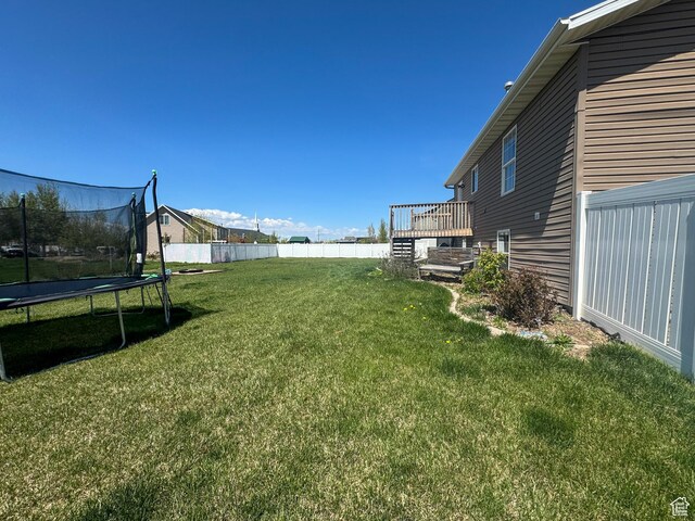 3261 S 1500 W, Nibley, UT 84321 - view of yard featuring fence, a trampoline, and a deck