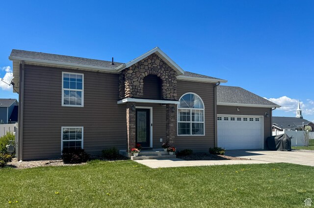 3261 S 1500 W, Nibley, UT 84321 - traditional home featuring fence, an attached garage, concrete driveway, and a front lawn