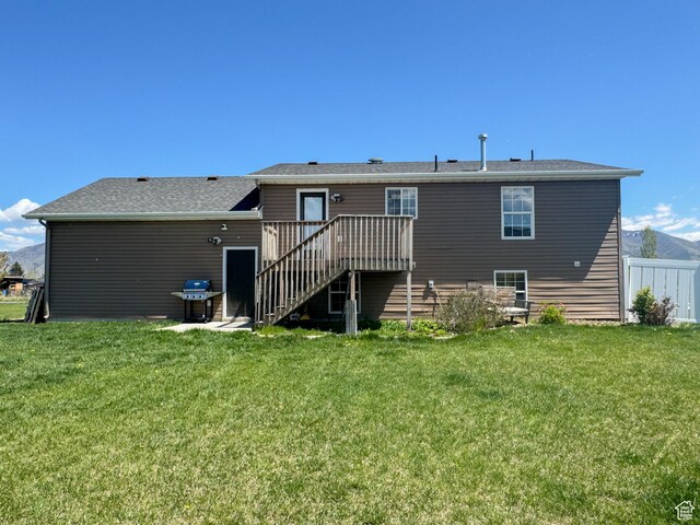 3261 S 1500 W, Nibley, UT 84321 - rear view of house with fence, a yard, stairway, and a deck