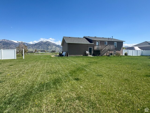 3261 S 1500 W, Nibley, UT 84321 - back of property with stairway, a deck with mountain view, a yard, and fence