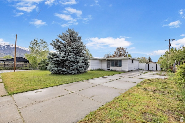 472 E Marva Ave, Layton, UT 84041 - view of front of home featuring a storage shed, concrete driveway, an outbuilding, and a front lawn