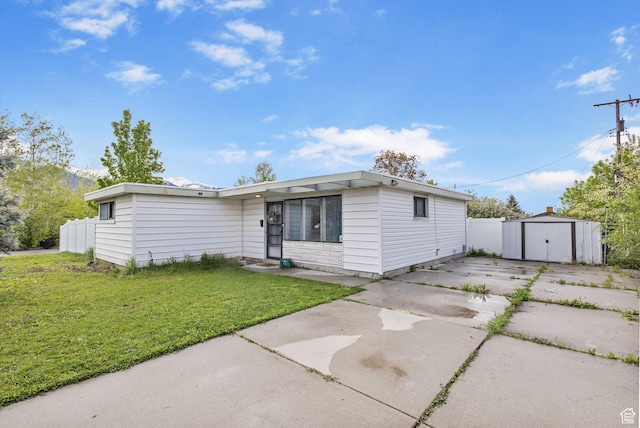 472 E Marva Ave, Layton, UT 84041 - view of front of home featuring a storage shed, an outbuilding, and driveway