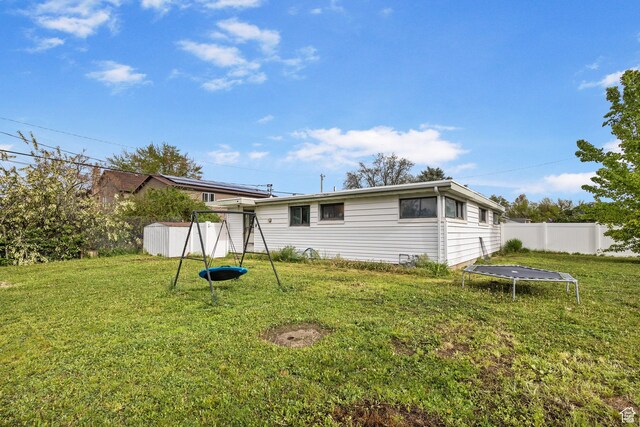 472 E Marva Ave, Layton, UT 84041 - rear view of property with a trampoline and a playground