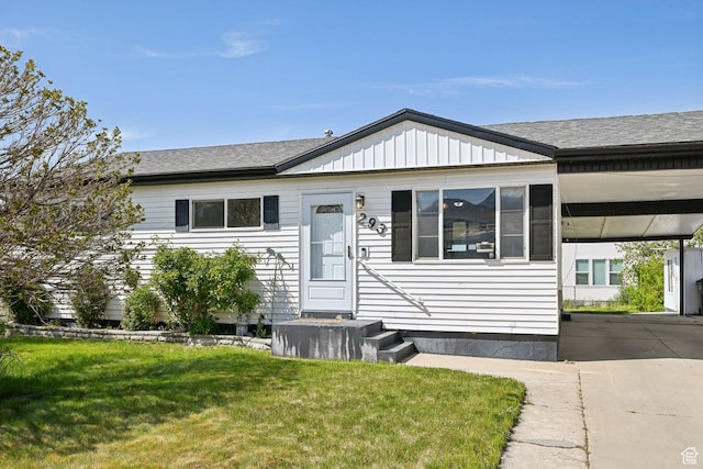 293 E Valley View Dr, Tooele, UT 84074 - view of front of home with a shingled roof, an attached carport, and a front yard