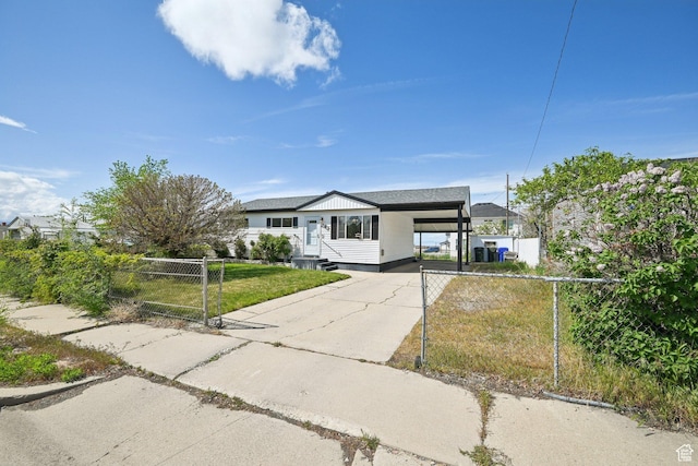 293 E Valley View Dr, Tooele, UT 84074 - ranch-style house featuring fence, a front yard, a gate, concrete driveway, and a carport