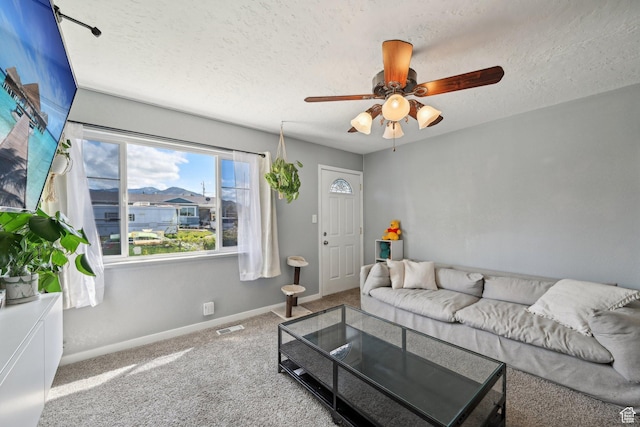 293 E Valley View Dr, Tooele, UT 84074 - carpeted living area with a textured ceiling, ceiling fan, visible vents, and baseboards