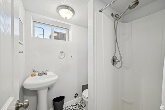 293 E Valley View Dr, Tooele, UT 84074 - full bath with baseboards, a sink, walk in shower, and toilet