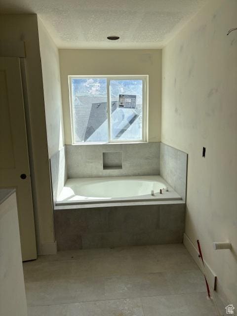 3636 N 500 E, North Ogden, UT 84414 - bathroom with tile patterned floors, a garden tub, and a textured ceiling