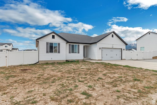197 W Phelps St S, Grantsville, UT 84029 - ranch-style house with fence, board and batten siding, an attached garage, and driveway