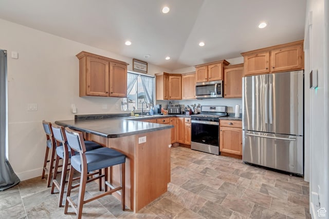 197 W Phelps St S, Grantsville, UT 84029 - kitchen with a peninsula, dark countertops, a breakfast bar area, recessed lighting, and stainless steel appliances
