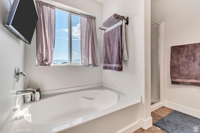 197 W Phelps St S, Grantsville, UT 84029 - full bath featuring baseboards, a shower stall, wood finished floors, and a bath