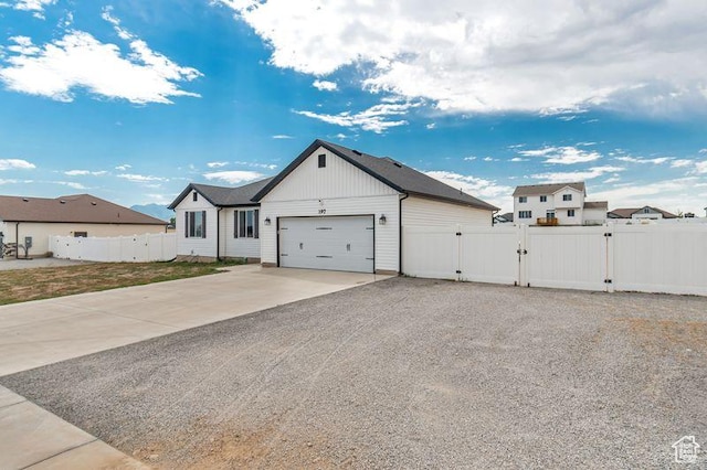 197 W Phelps St S, Grantsville, UT 84029 - modern farmhouse featuring a garage, a gate, fence, and concrete driveway