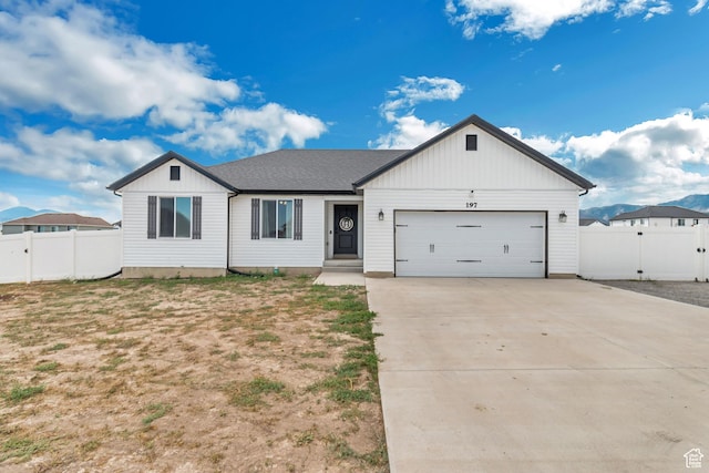 197 W Phelps St S, Grantsville, UT 84029 - ranch-style house featuring a garage, board and batten siding, fence, and concrete driveway