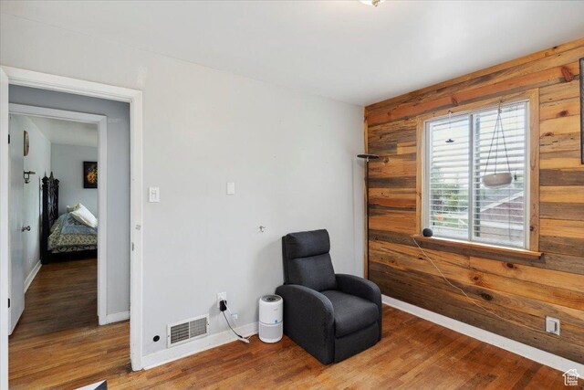 968 Bel Mar Dr, Ogden, UT 84403 - living area with wooden walls, baseboards, wood finished floors, and visible vents