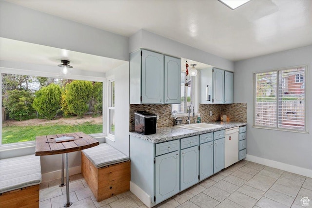 968 Bel Mar Dr, Ogden, UT 84403 - kitchen with baseboards, white dishwasher, tasteful backsplash, a sink, and light tile patterned floors