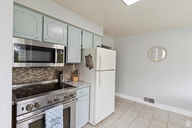 968 Bel Mar Dr, Ogden, UT 84403 - kitchen featuring visible vents, light tile patterned flooring, baseboards, appliances with stainless steel finishes, and backsplash