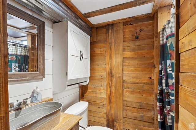 968 Bel Mar Dr, Ogden, UT 84403 - bathroom with a sink, toilet, and wood walls