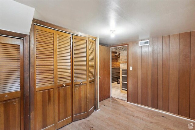 968 Bel Mar Dr, Ogden, UT 84403 - hallway featuring visible vents, wood walls, and light wood-type flooring