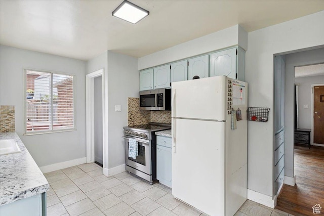 968 Bel Mar Dr, Ogden, UT 84403 - kitchen with light countertops, stainless steel appliances, baseboards, and tasteful backsplash