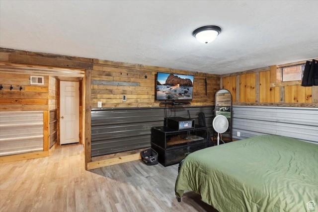 968 Bel Mar Dr, Ogden, UT 84403 - bedroom featuring wooden walls, light wood-style floors, and visible vents