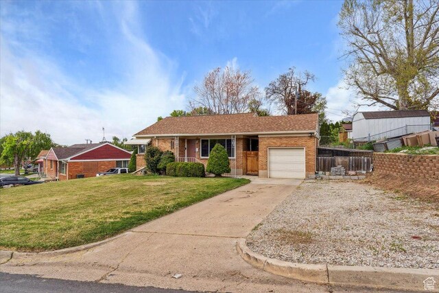 968 Bel Mar Dr, Ogden, UT 84403 - ranch-style house with a front yard, brick siding, fence, concrete driveway, and an attached garage