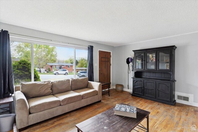 968 Bel Mar Dr, Ogden, UT 84403 - living room with a textured ceiling, baseboards, wood finished floors, and visible vents