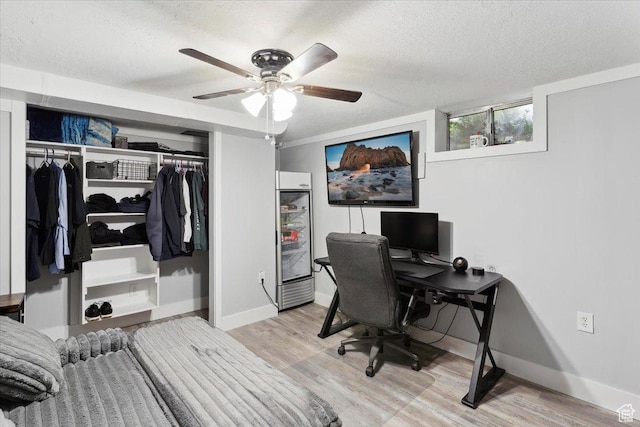 968 Bel Mar Dr, Ogden, UT 84403 - home office with a textured ceiling, baseboards, a ceiling fan, and light wood-style flooring