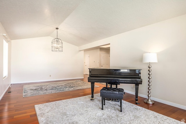 176 N 170 E, Orem, UT 84057 - sitting room with a textured ceiling, a notable chandelier, baseboards, wood-type flooring, and lofted ceiling