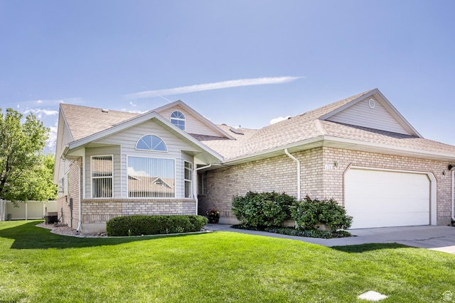 176 N 170 E, Orem, UT 84057 - view of front of home with brick siding, a garage, a shingled roof, and a front lawn