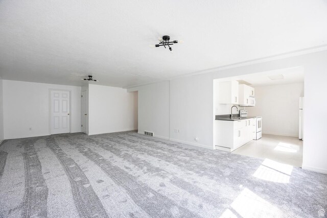 176 N 170 E, Orem, UT 84057 - unfurnished living room featuring baseboards, light colored carpet, a sink, and visible vents