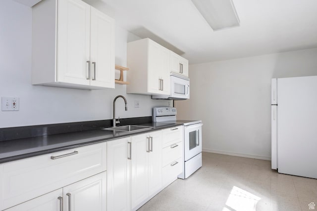 176 N 170 E, Orem, UT 84057 - kitchen featuring dark countertops, a sink, white appliances, white cabinetry, and light floors